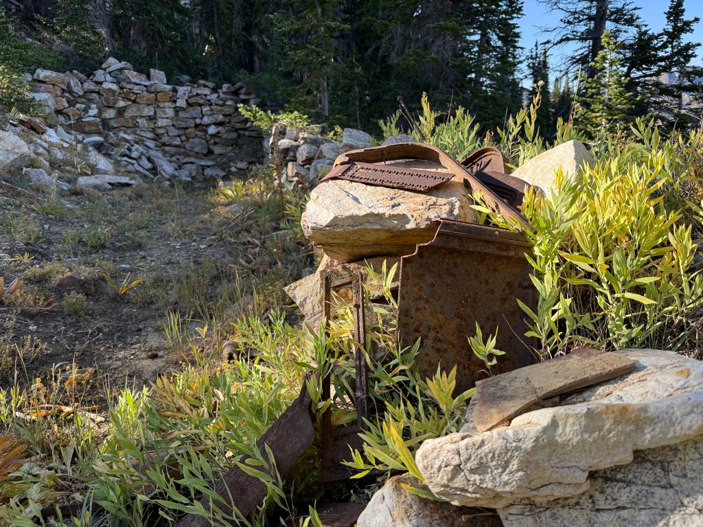 Rusted metal on a rock wall from the Carbonate Mine camp