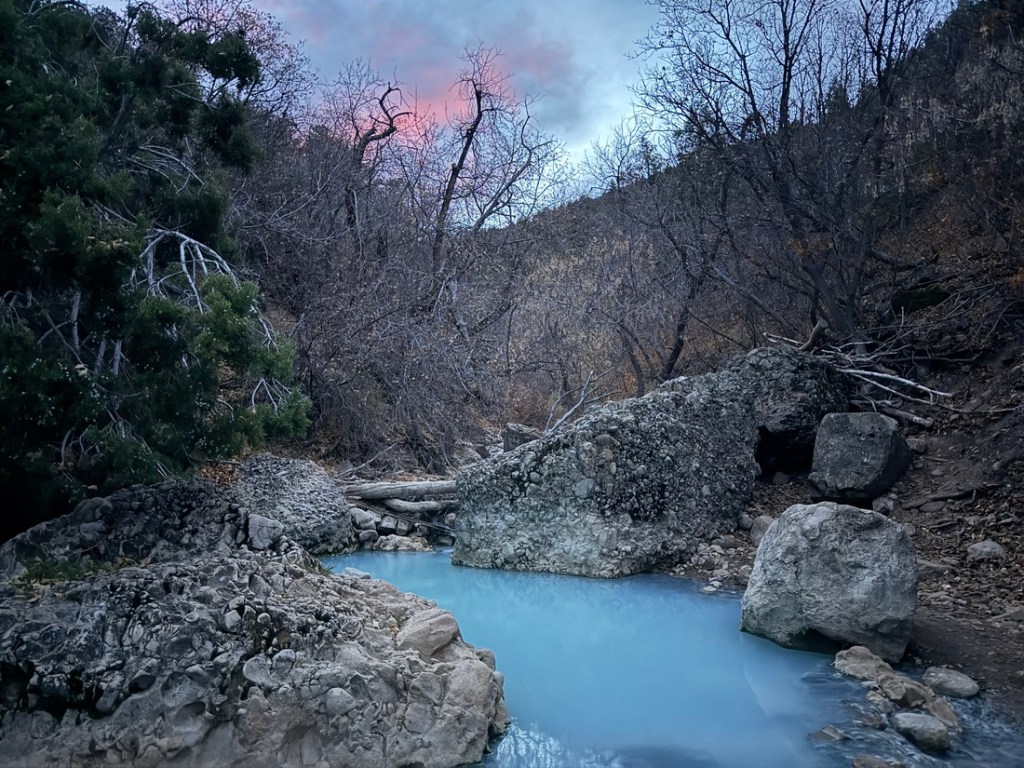 Blue water and pink sky at Fifth Water Hot Springs