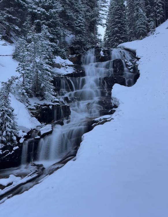 Gloria Falls flowing through the snow