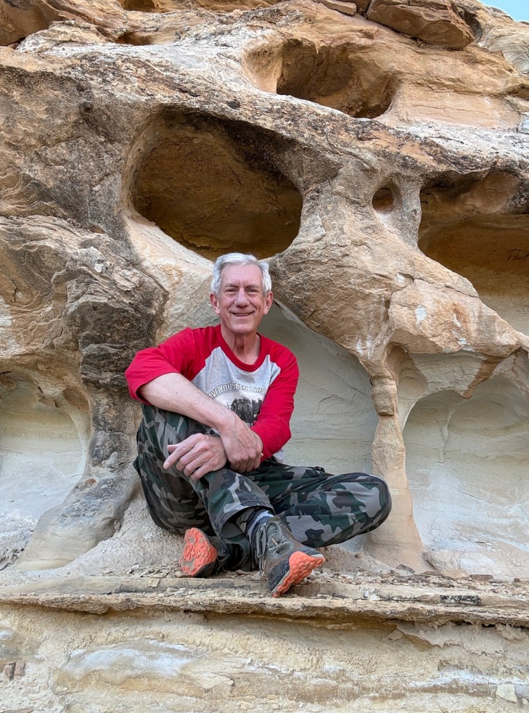 Old Hiking Dude relaxing in Little Wild Horse Canyon Utah