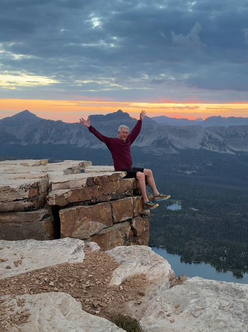 Old Hiking Dude sitting on a cliff on Bald Mountain at sunrise